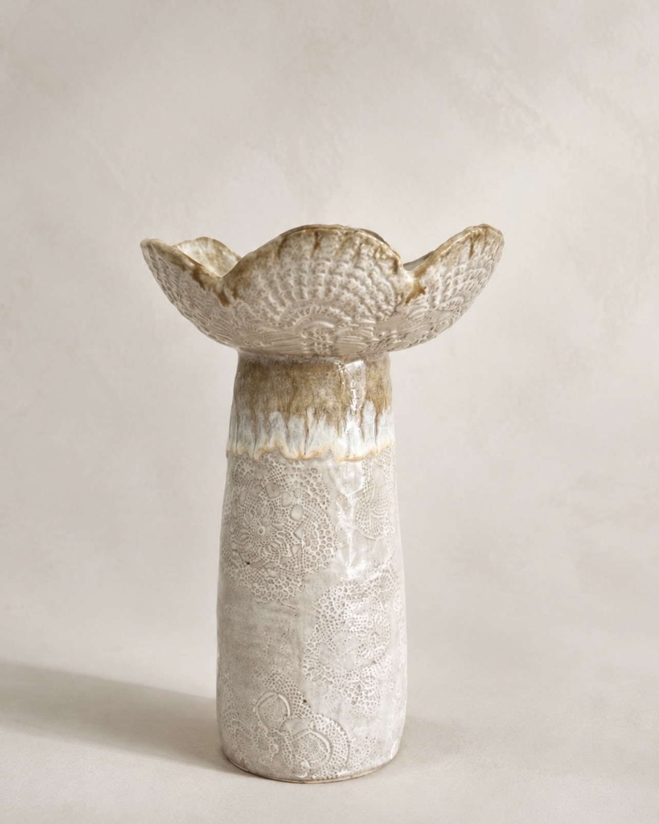 Tall lace-textured ceramic vase with a sculptural flower-shaped rim