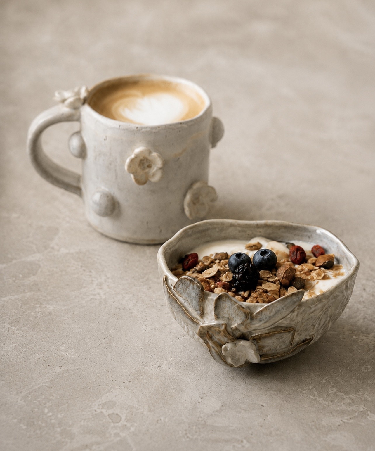 Floral ceramic mug and textured bowl served with coffee and breakfast