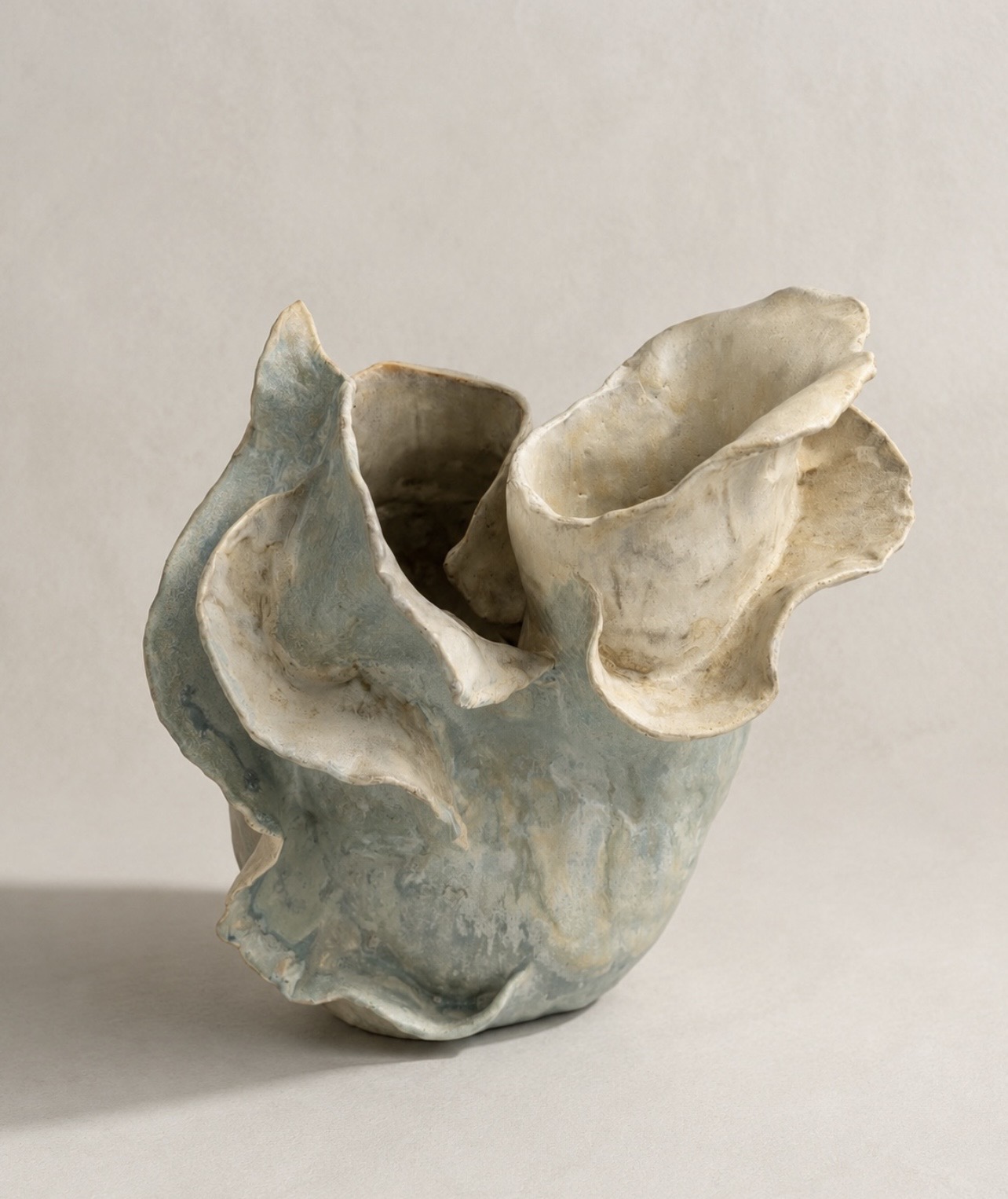 Blue and ivory handbuilt sculptural vessel with folded organic edges