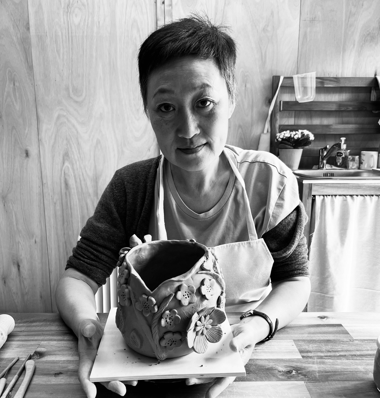 Guest holding her finished floral handbuilt vessel